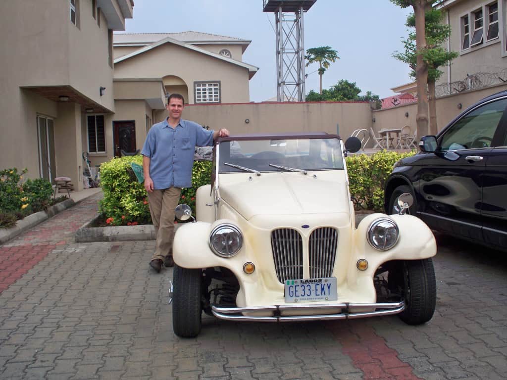 Steve Roller standing with a off white vintage car