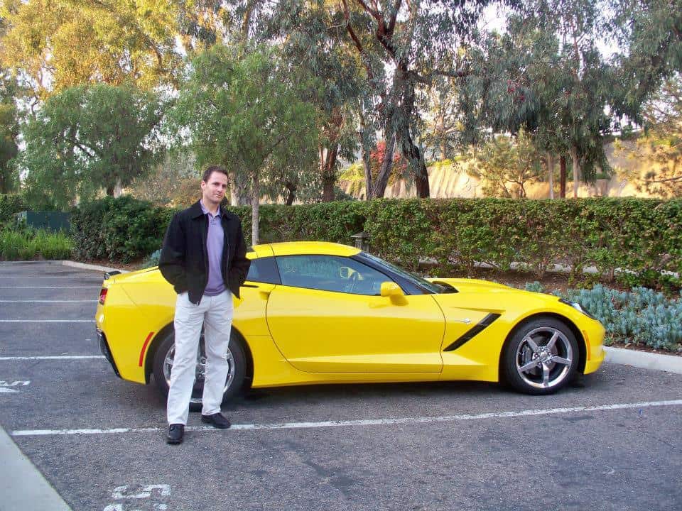 Steve standing next to a yellow sports car